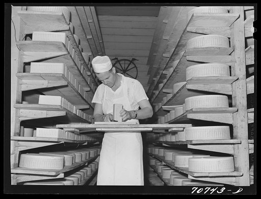Untitled photo, possibly related to: Tillamook cheese plant, Tillamook, Oregon. Trimming mold off aging cheese