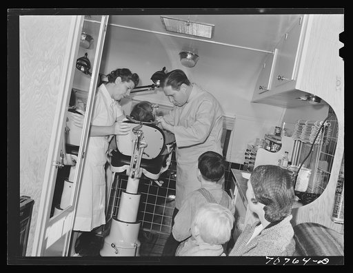Untitled photo, possibly related to: FSA (Farm Security Administration) dentist and migrant child in the FSA dental trailer at the FSA camp for farm families. Caldwell, Idaho