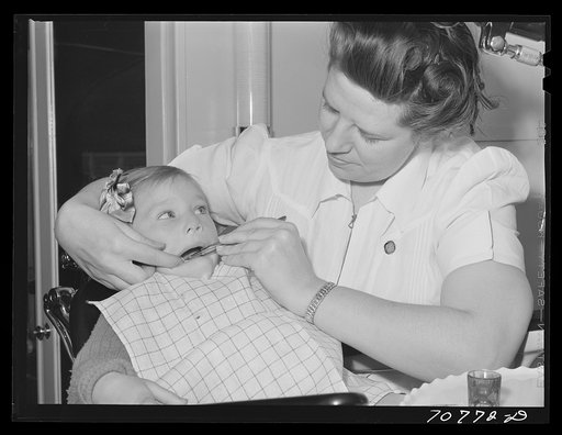 FSA (Farm Security Administration) nurse examines the teeth of migrant in the FSA dental trailer at the FSA camp for farm workers. Caldwell, Idaho
