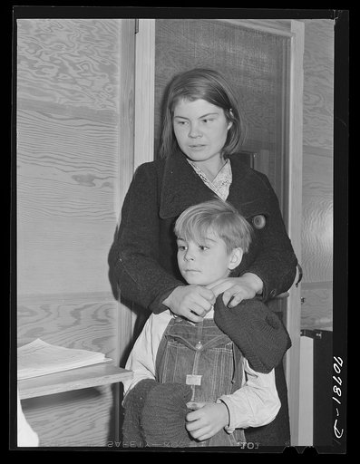 Two migrant children register with the nurse in the FSA (Farm Security Administration) dental trailer while it is parked at the FSA camp for farm families. Caldwell, Idaho