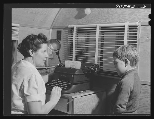 Untitled photo, possibly related to: The FSA (Farm Security Administration) nurse types out dental record of migrant child in the dental trailer while at the FSA camp for farm workers. Caldwell, Idaho