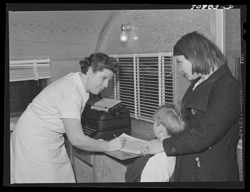 Two migrant children register with the nurse in the FSA (Farm Security Administration) dental trailer while it is parked at the FSA camp for farm families. Caldwell, Idaho