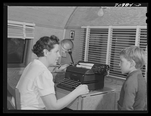 The FSA (Farm Security Administration) nurse types out dental record of migrant child in the dental trailer while at the FSA camp for farm workers. Caldwell, Idaho