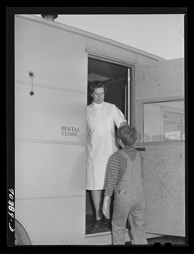 Untitled photo, possibly related to: The FSA (Farm Security Administration) nurse welcomes migrant boy to FSA dental trailer at the FSA camp for farm families. Caldwell, Idaho