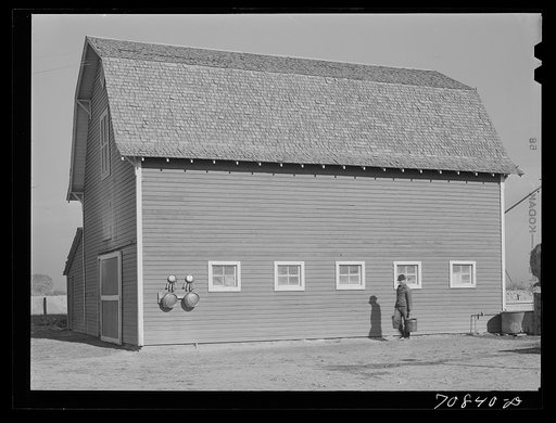 Farmer and his barn. Black Canyon Project, Canyon County, Idaho