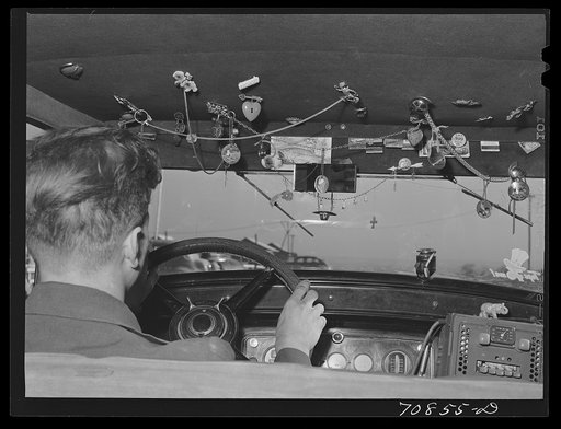 Trinkets in agricultural worker's automobile. Wilder, Idaho