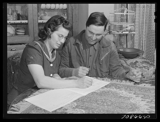 Mr. and Mrs. Lee Wagoner work on farm records. They live on the Black Canyon Project. Canyon County, Idaho