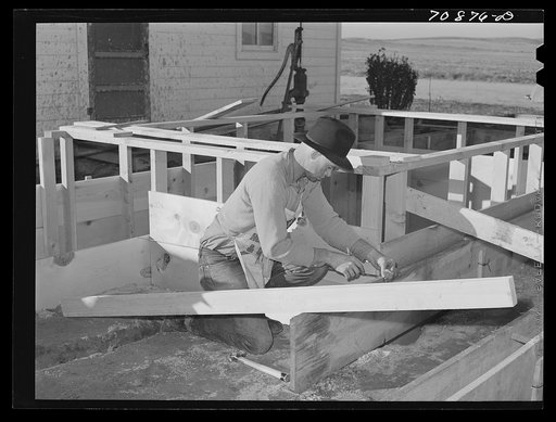 Carpenter building house on Black Canyon Project. Canyon County, Idaho