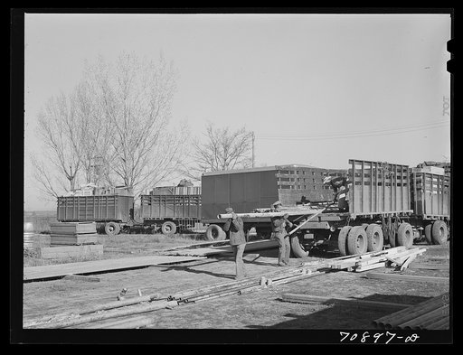 Unloading equipment from the FSA (Farm Security Administration) mobile camps at the permanent camp at Caldwell, Idaho