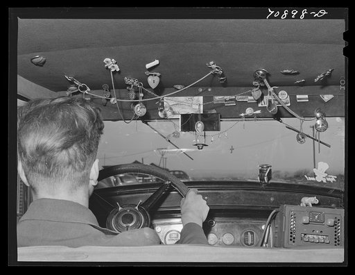 Untitled photo, possibly related to: Trinkets in agricultural worker's automobile. Wilder, Idaho