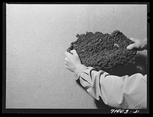 Untitled photo, possibly related to: Salinas, California. Intercontinental Rubber Producers. Guayule rubber after it has been through the dryer and first roller in the factory. In later operations the rubber is heated and put under pressure to form blocks of rubber