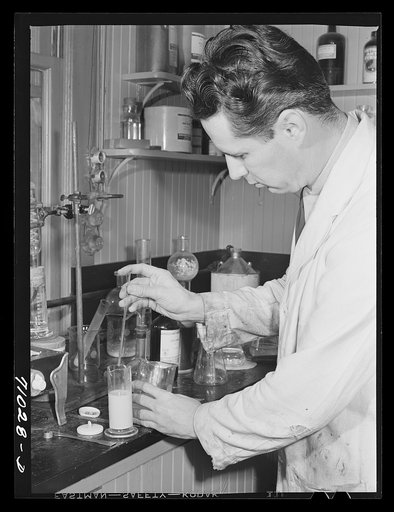 Salinas, California. Intercontinental Rubber Producers. Harry Baucher, head chemist, works on deresinating tests