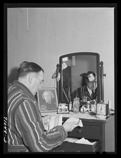 Vallejo, California. Workman at Mare Island shipbuilding yards in his room at FSA (Farm Security Administration) dormitories