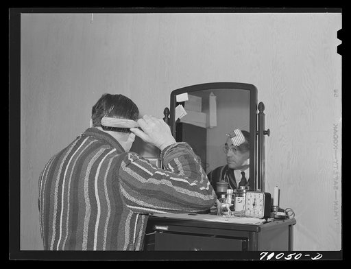 Vallejo, California. Workman at Mare Island shipbuilding yards in his room at FSA (Farm Security Administration) dormitories