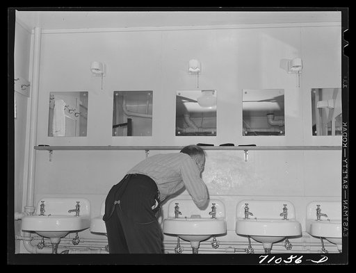 Untitled photo, possibly related to: Vallejo, California. Workman at Mare Island shipbuilding yards in bathroom of FSA (Farm Security Administration) dormitory