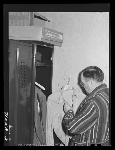 Vallejo, California. Workman at Mare Island shipbuilding yards in his room at the FSA (Farm Security Administration) dormitories