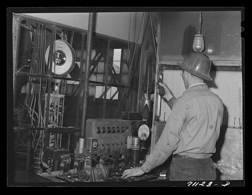 This workman controls amounts of materials going into concrete used in construction of Shasta Dam. Shasta County, California
