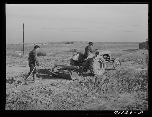 Mr. Palmer and son level land where farm buildings will be. Canyon County, Idaho. He has a FSA (Farm Security Administration) real estate loan which will enable him to put up house, etc.