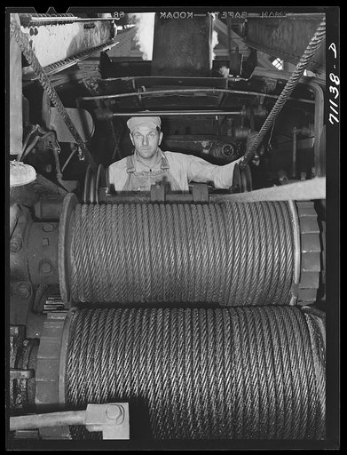 Tending the cables on which cable cars run to transport materials in construction of Shasta Dam. Shasta County, California