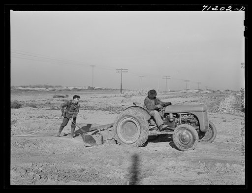 Untitled photo, possibly related to: Mr. Palmer and son level land where farm buildings will be. Canyon County, Idaho. He has a FSA (Farm Security Administration) real estate loan which will enable him to put up house, etc.
