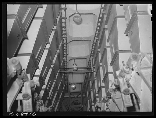 Untitled photo, possibly related to: Petaluma, Sonoma County, California. Hoppers which hold different grains. These mixtures are used for chicken feed