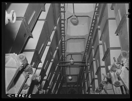 Untitled photo, possibly related to: Petaluma, Sonoma County, California. Hoppers which hold different grains. These mixtures are used for chicken feed