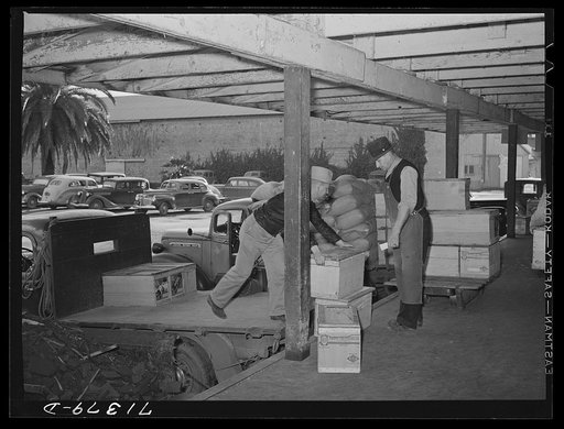 Petaluma, Sonoma County, California. Putting crates of eggs onto a truck for transporting to the market