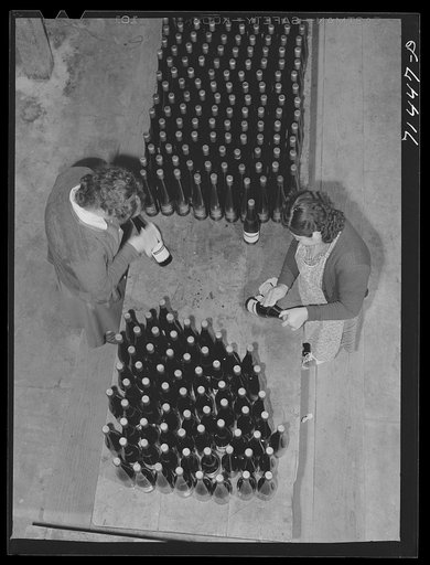 Sonoma County, California. Labeling bottle of wine at winery
