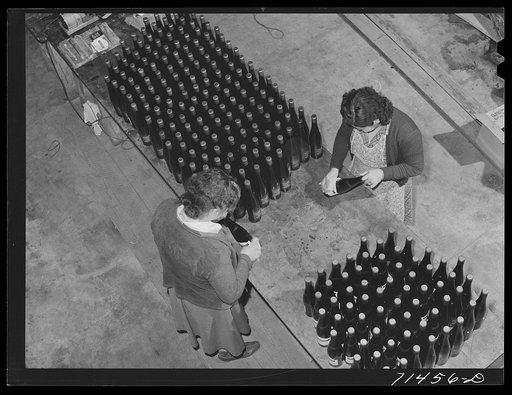 Sonoma County, California. Labeling bottles of wine at the winery