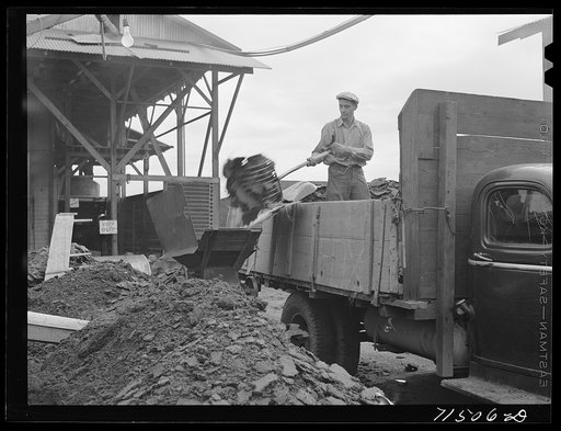 Untitled photo, possibly related to: Handling the cake from which "soap" oil will be extracted by means of a solvent. Strathmore, California