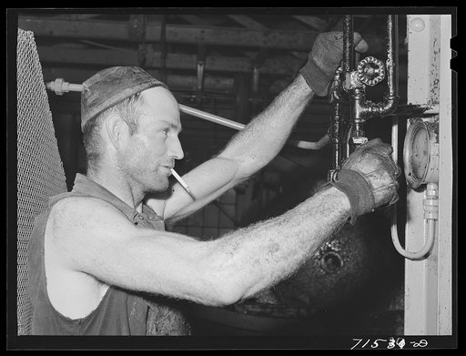 Lindsay, California. The pressure of the olive press must be carefully watched, for different degrees of pressure are prescribed for the two pressings. The first yields the virgin oil, about twenty-five percent of the total oil content of the olives; the second yields refined oil