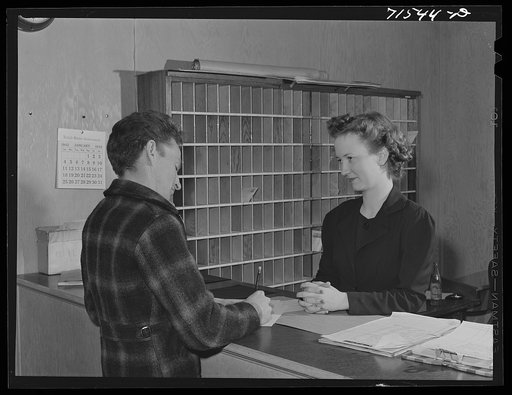 Workman registering at office of the FSA (Farm Security Administration) defense dormitories at Vallejo, California. These dormitories are for the workmen at the Mare Island navy yards