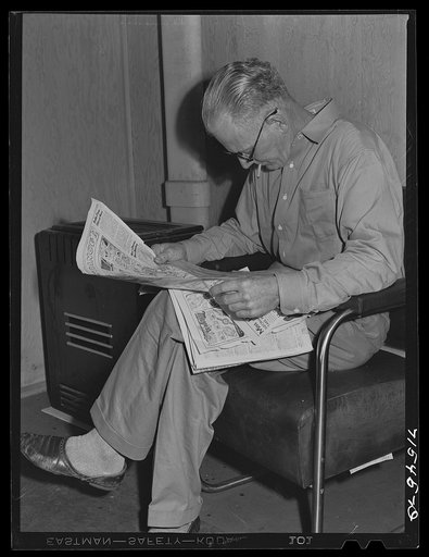Workman at the Mare Island navy yards in the community room at FSA (Farm Security Administration) defense housing dormitories at Vallejo, California. Each dormitory has its own community room