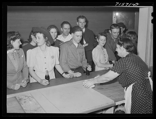 Untitled photo, possibly related to: Woodville, California. FSA (Farm Security Administration) farm workers' community. Migrant agricultural workers eating hamburgers at the Saturday night dance