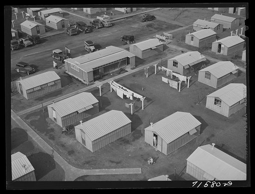 Untitled photo, possibly related to: Woodville, California. FSA (Farm Security Administration) farm workers' community. Metal shelters are grouped about the utility building