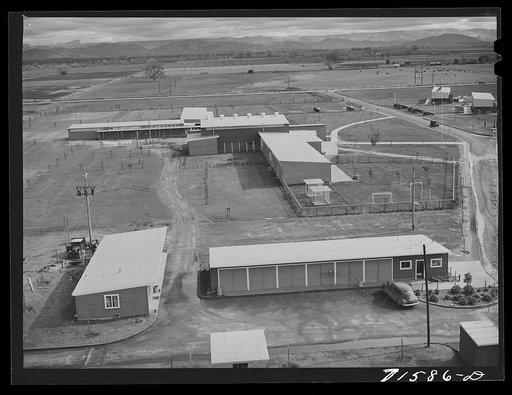 Untitled photo, possibly related to: Woodville, California. FSA (Farm Security Administration) farm workers' community. Community buildings in the background, office building and staff automobile garages in the foreground