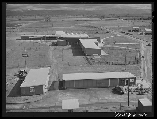 Woodville, California. FSA (Farm Security Administration) farm workers' community. Community buildings in the background, office building and staff automobile garages in the foreground
