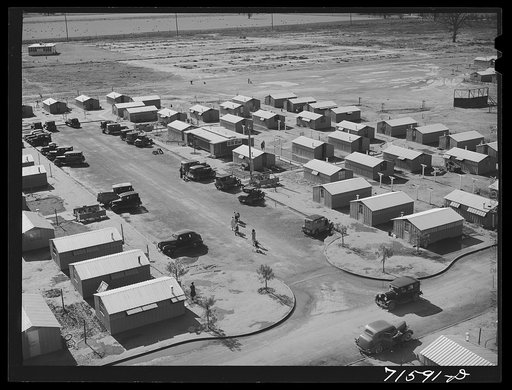 Woodville, California. FSA (Farm Security Administration) farm workers' community. Metal shelters for agricultural workers are grouped about the utility building
