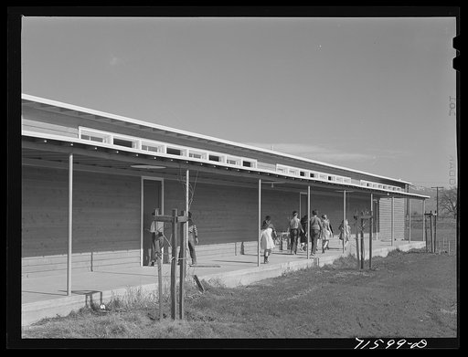 Woodville, California. FSA (Farm Security Administration) farm workers' community. Outside passageways are an important feature of the community building which is used as a school