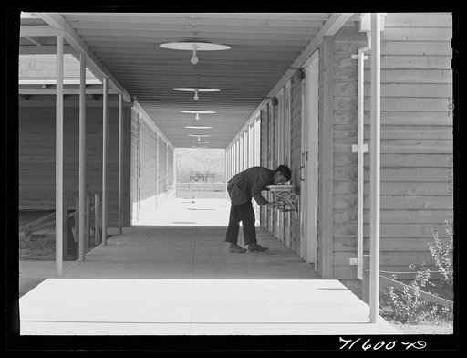Untitled photo, possibly related to: Woodville, California. FSA (Farm Security Administration) farm workers' community. Outside passageways are used wherever possible in the community building