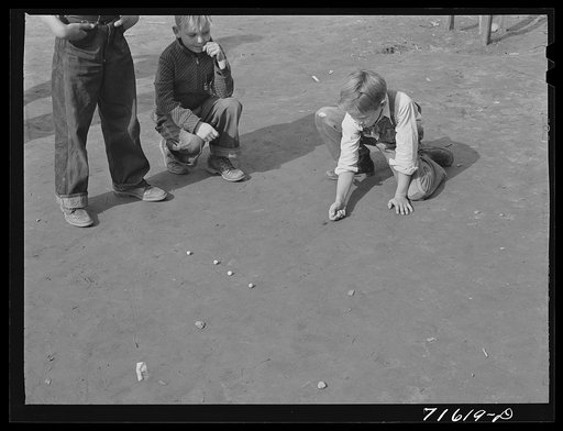 Untitled photo, possibly related to: Woodville, California. FSA (Farm Security Administration) farm workers' community. Sons of migrant agricultural workers playing marbles