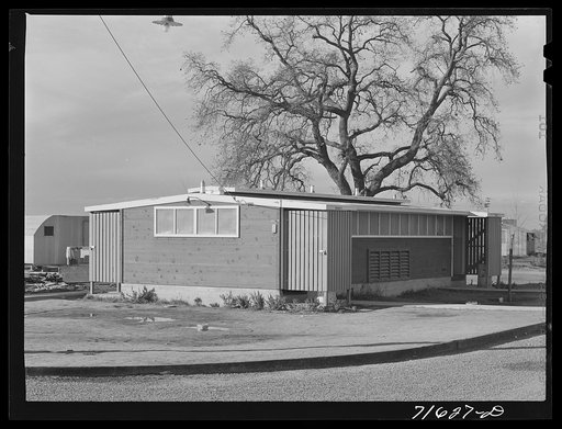 Woodville, California. FSA (Farm Security Administration) farm workers' community. Row of metal shelters