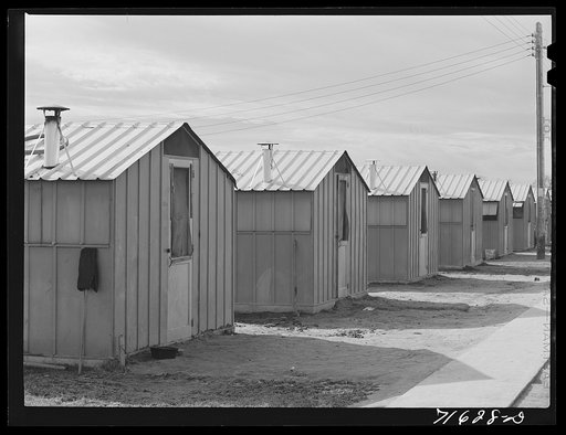 Woodville, California. FSA (Farm Security Administration) farm workers' community. Row of metal shelters