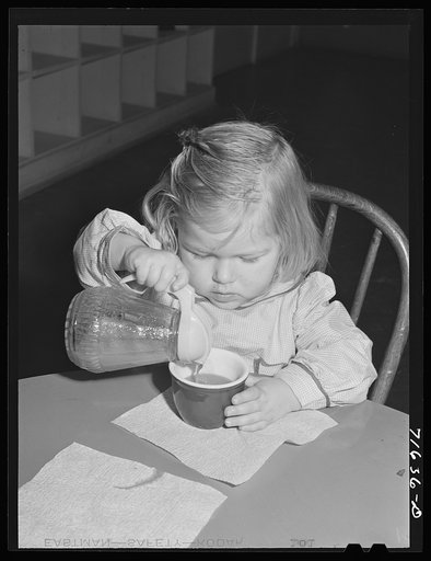 Woodville, California. FSA (Farm Security Administration) farm workers' community. Little girl drinking her orange juice at the nursery school