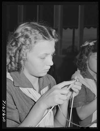 Tulare County, California. FSA (Farm Security Administration) farm workers' camp. Girl scout learning to knit