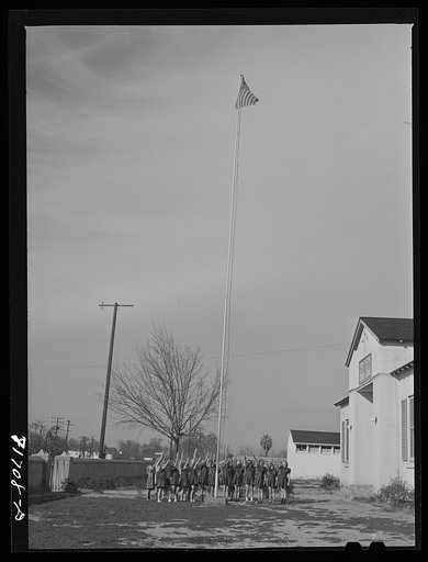 Untitled photo, possibly related to: Tulare County, California. FSA (Farm Security Administration) farm workers' camp. Brownies (junior Girl Scouts) saluting the flag