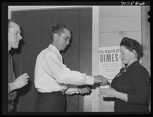 Tulare County, California. FSA (Farm Security Administration) farm workers' camp. Agricultural worker contributing his dime at the President's birthday ball