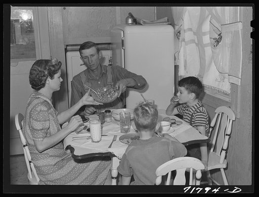 Woodville, California. FSA (Farm Security Administration) farm workers' community. Agricultural worker and his family in their garden house