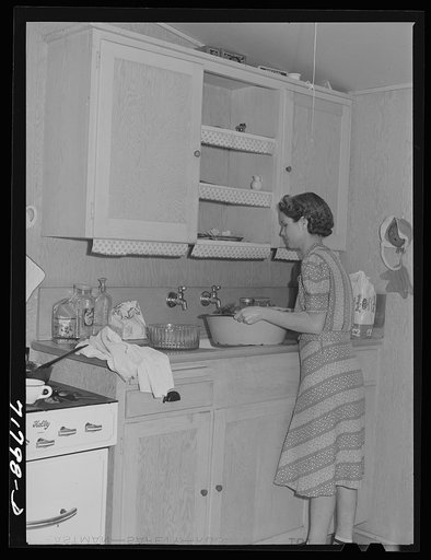 Woodville, California. FSA (Farm Security Administration) farm workers' community. Wife of agricultural worker in the kitchen of her garden house