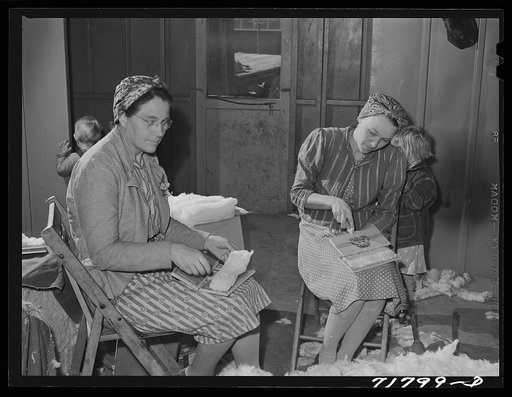 Woodville, California. FSA (Farm Security Administration) farm workers' community. Carding surplus cotton which will be used for quilts